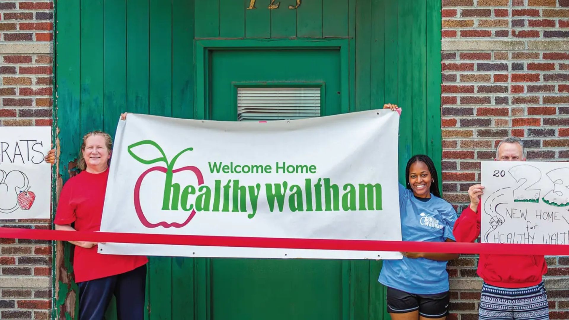 A group of people holding up a sign that says "Healthy Waltham."